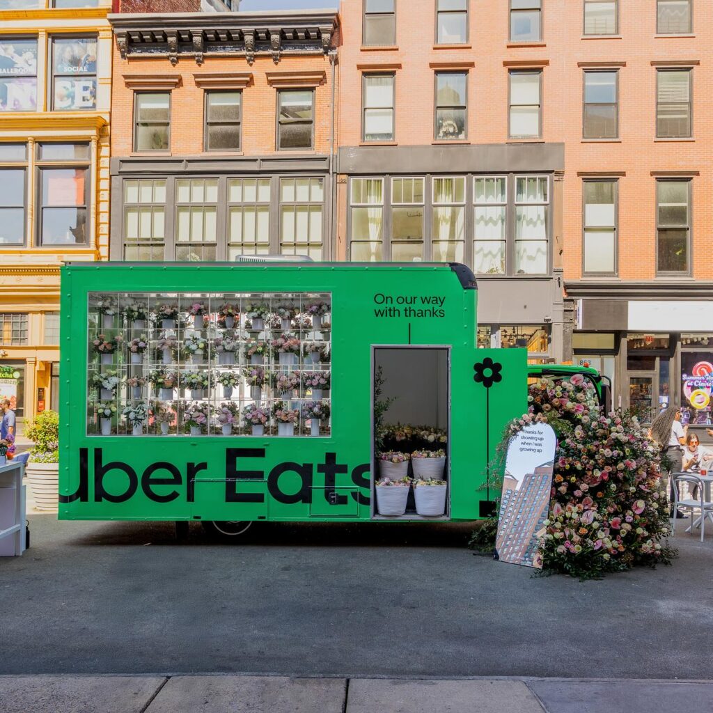 Guests writing notes and receiving bouquets at Uber Eats pop-up — brand experience rooted in emotional branding.