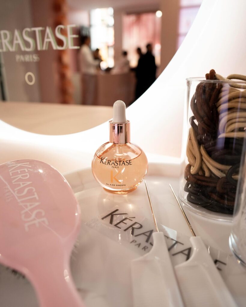 Charm bar and styling stations at Kérastase pop-up — brand experience designed for emotional connection.